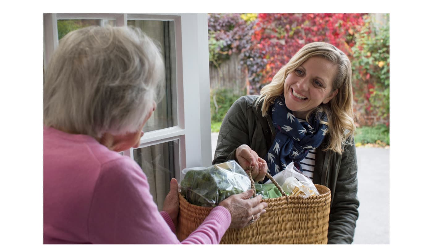 A neighbor delivering a basket of food